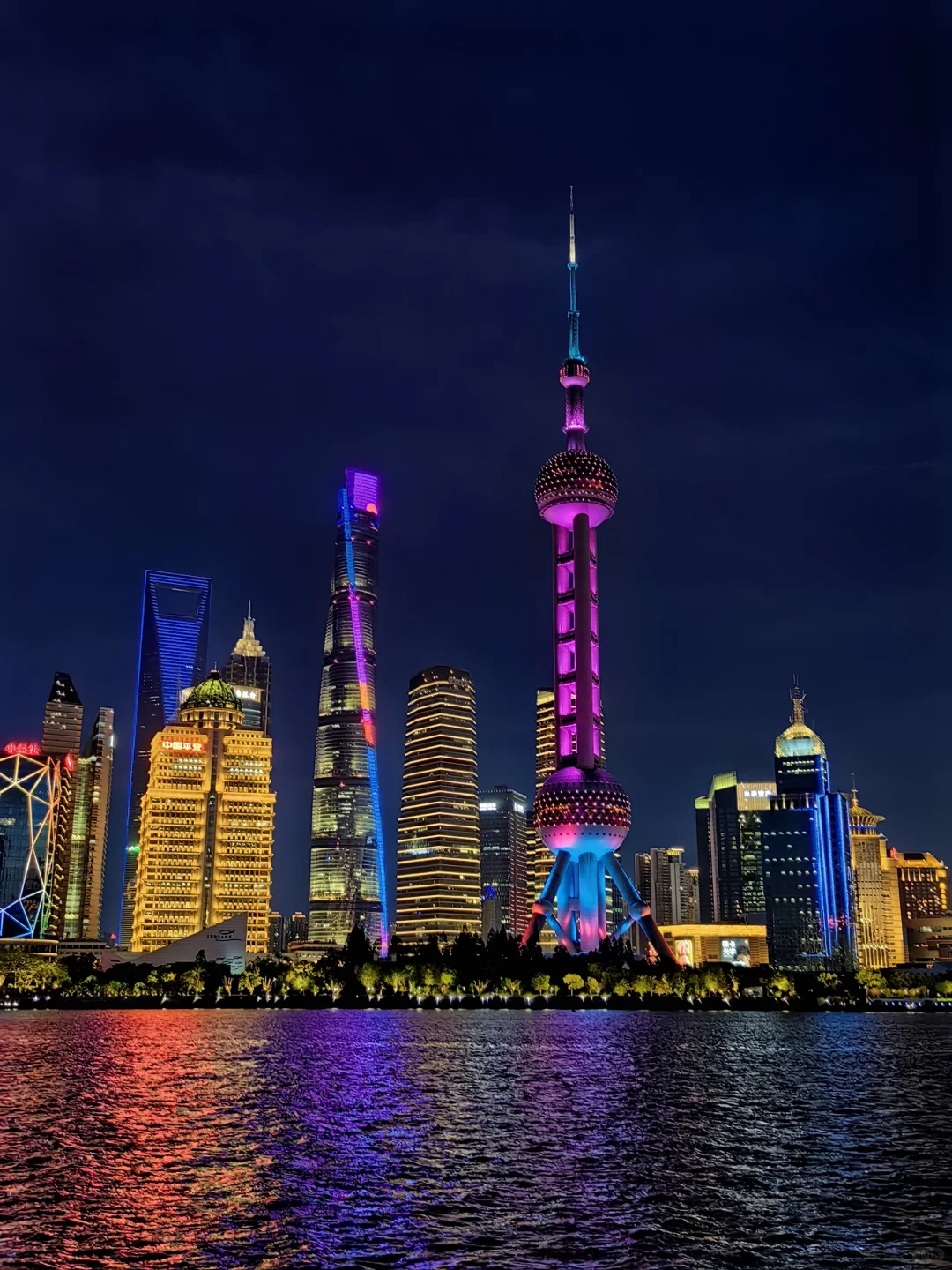 Shanghai skyline glowing at night with colorful lights