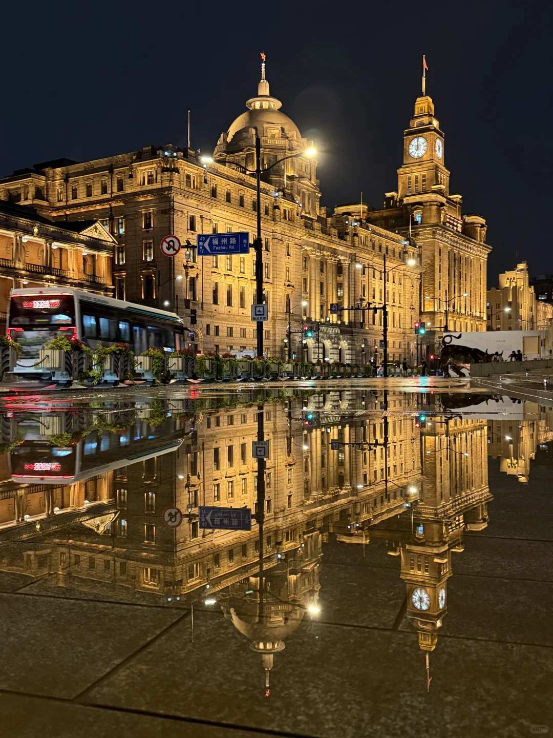 Rainy street scene in Shanghai with people holding umbrellas