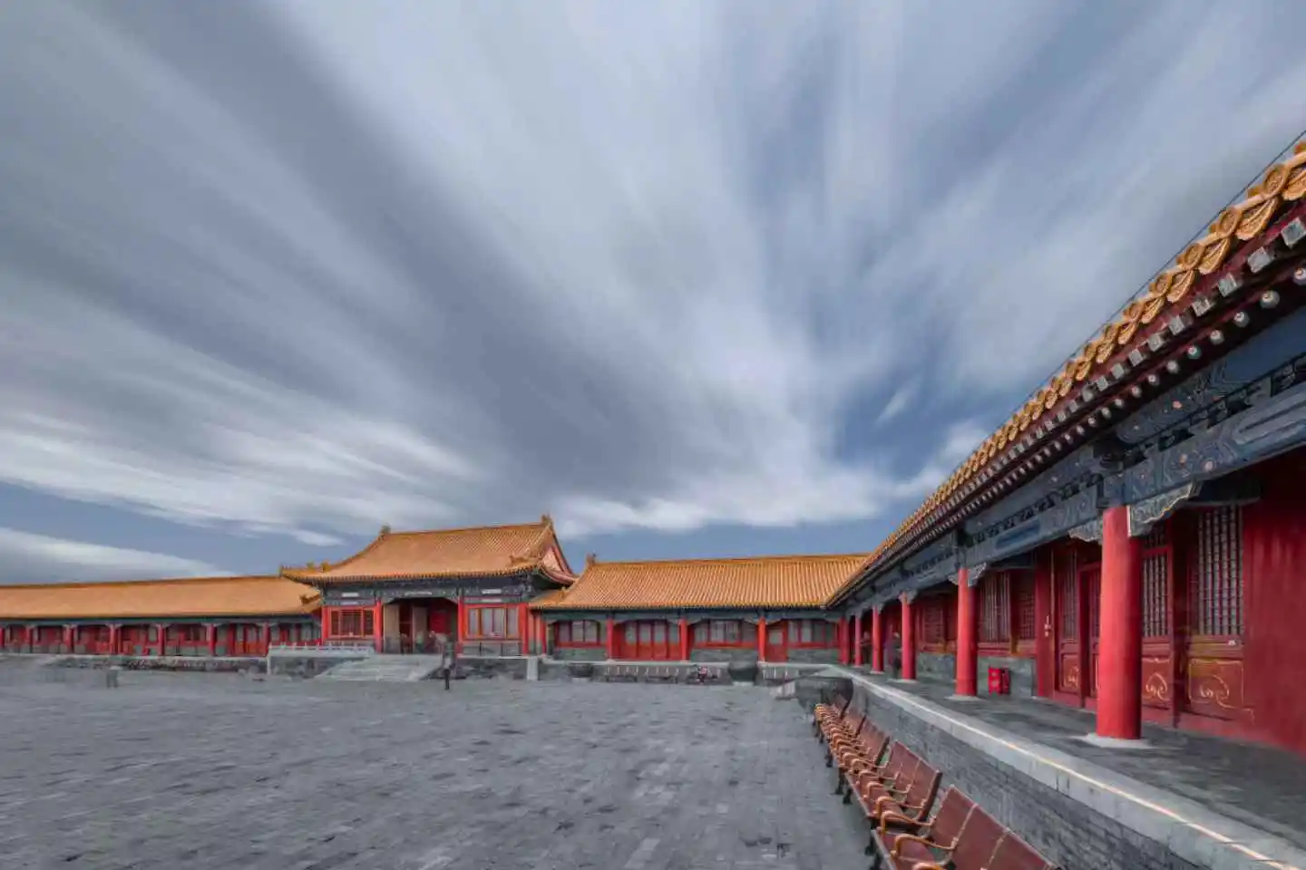 Sunlight breaking through clouds over the palace