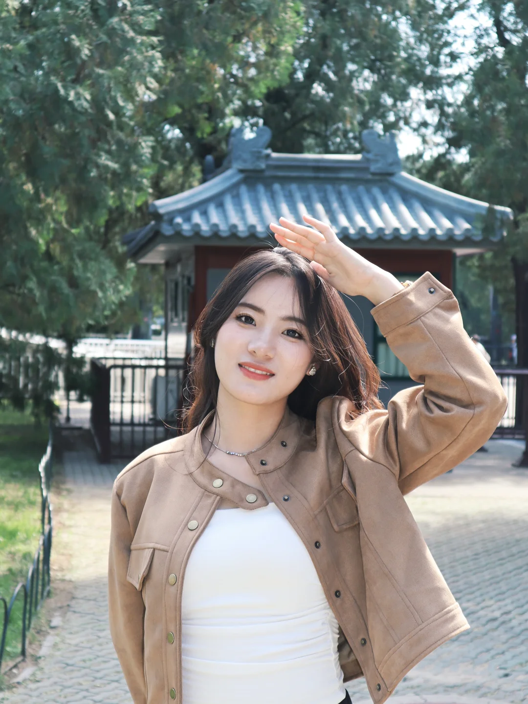 Symmetrical photo showcasing temple’s red wall and blue tiles