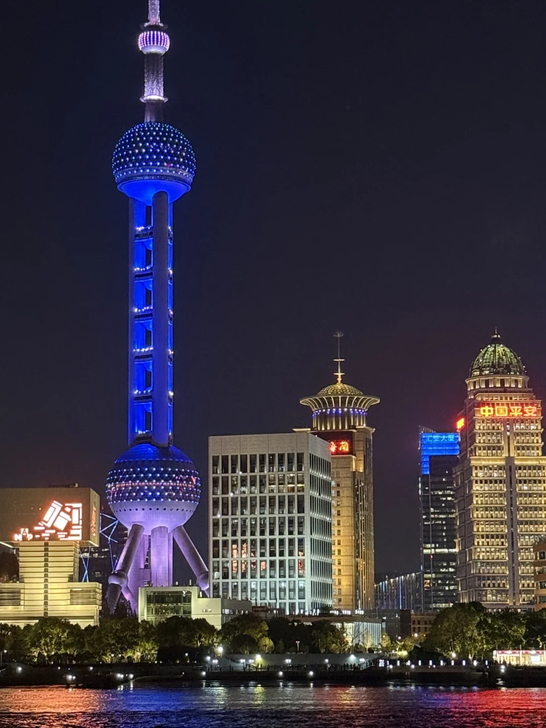 Shanghai riverside night lights and skyline reflection