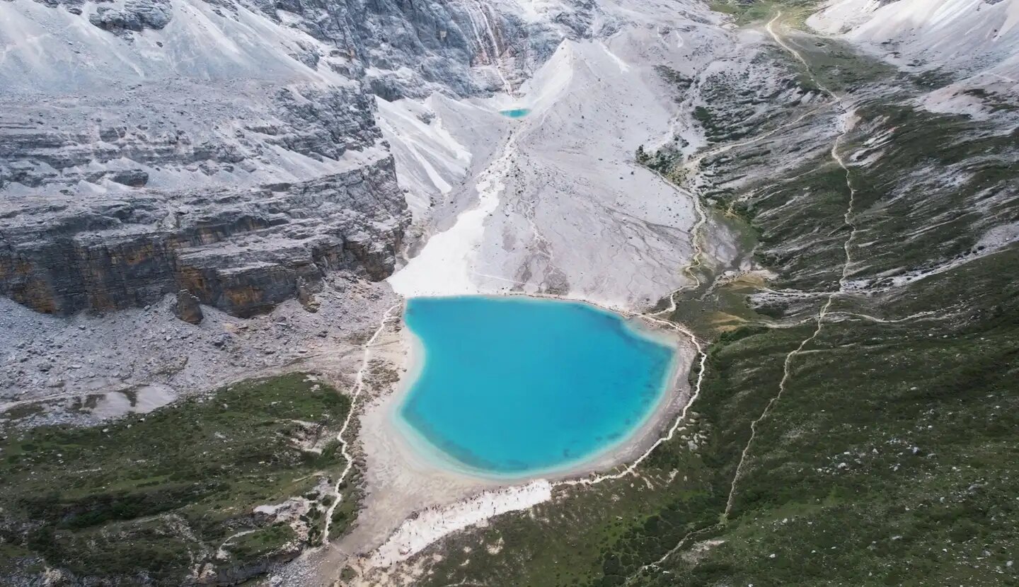 A broad blue lake and mountain landscape used for western China trip planning