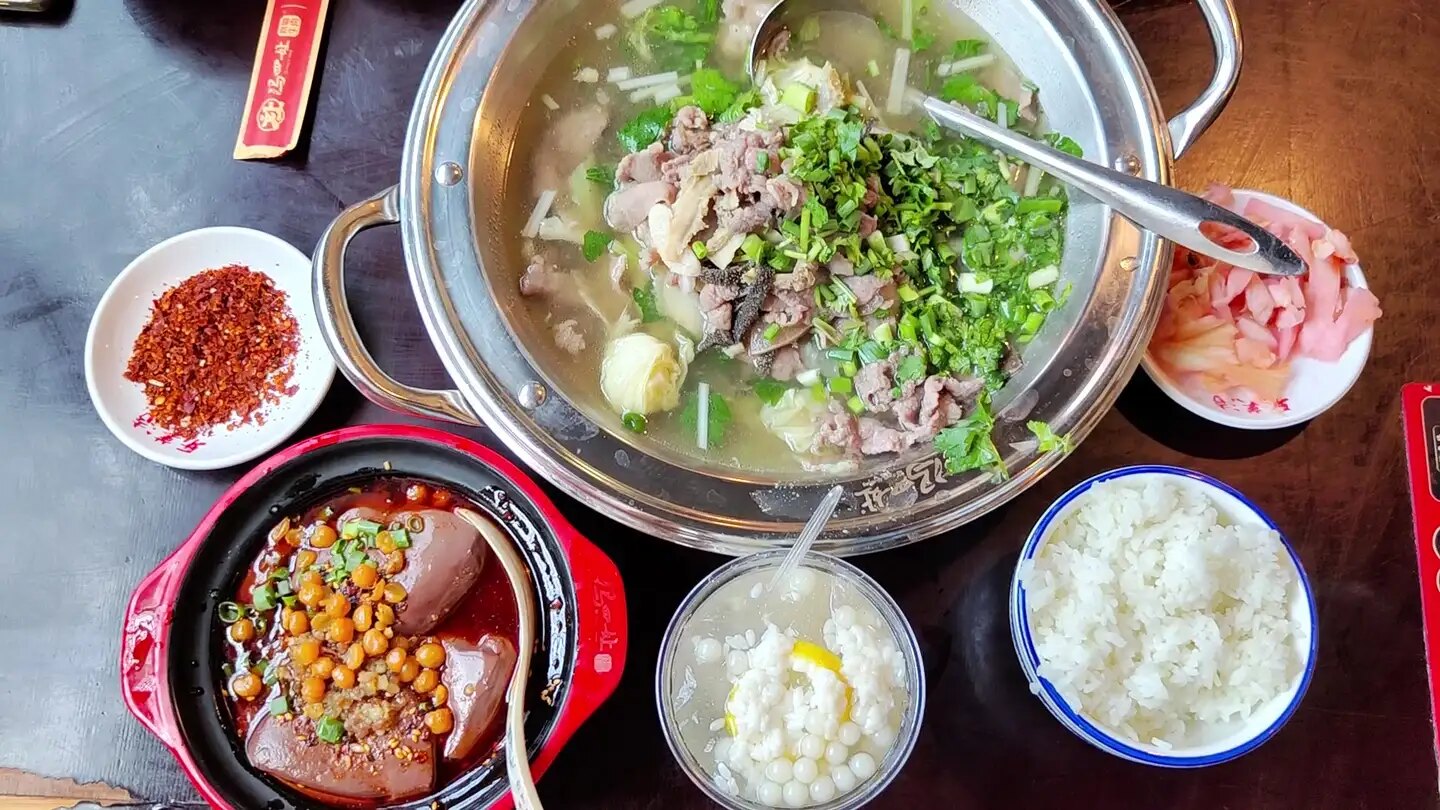A shared Chinese meal with multiple dishes on the table