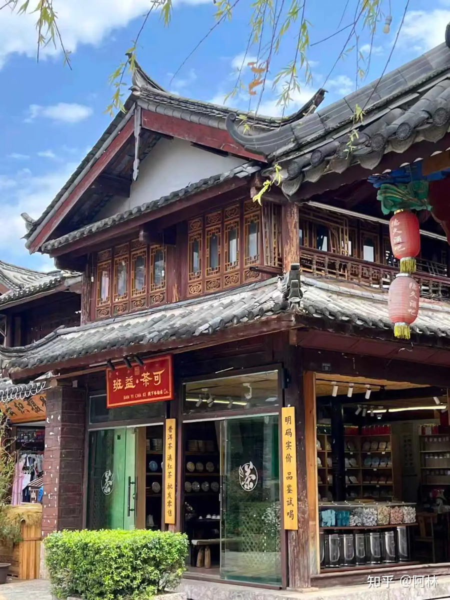 Traditional Lijiang tea shop exterior with wooden facade and hanging signs