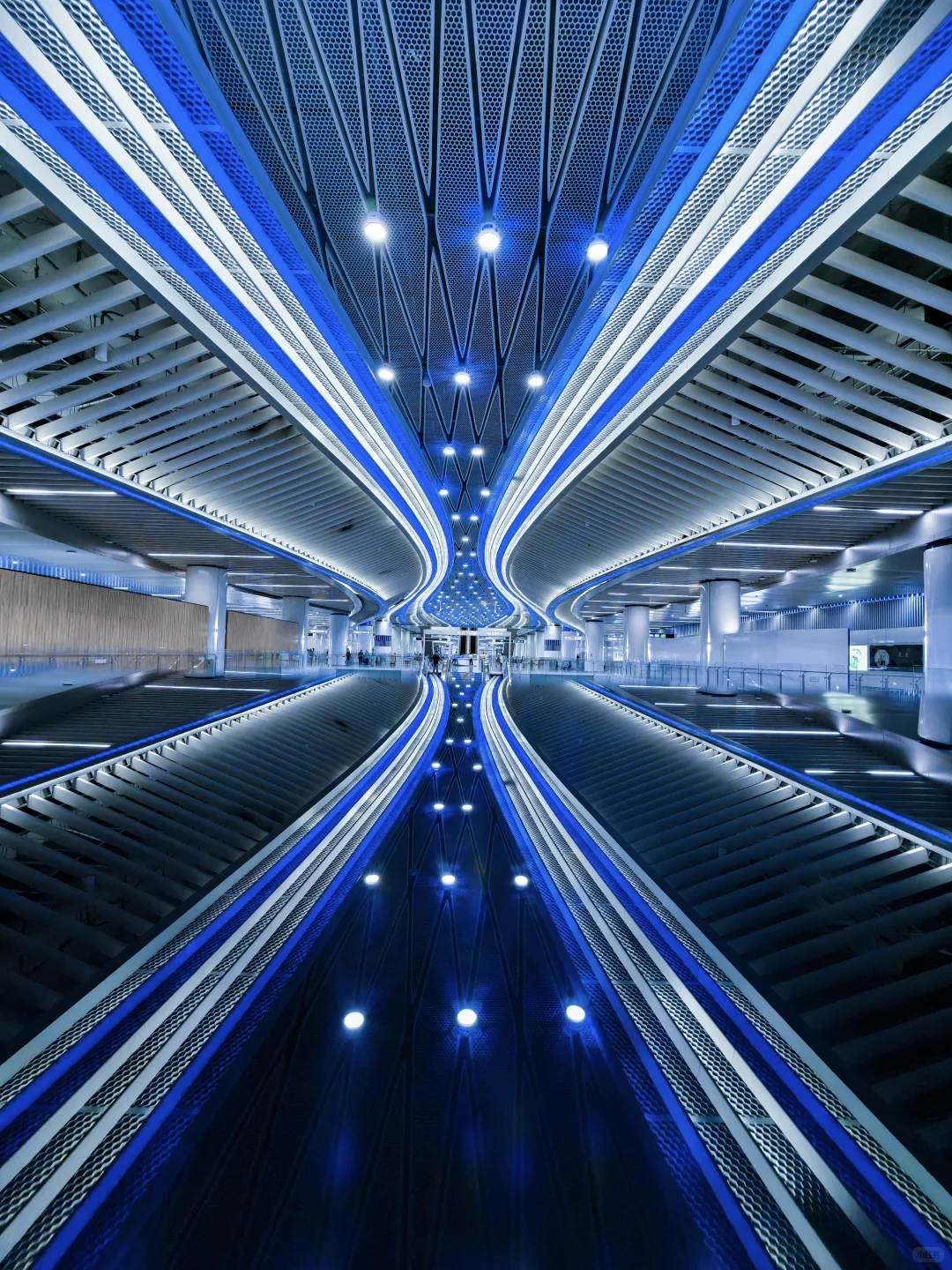 Blue symmetrical lines inside a futuristic Guangzhou transit or commercial interior