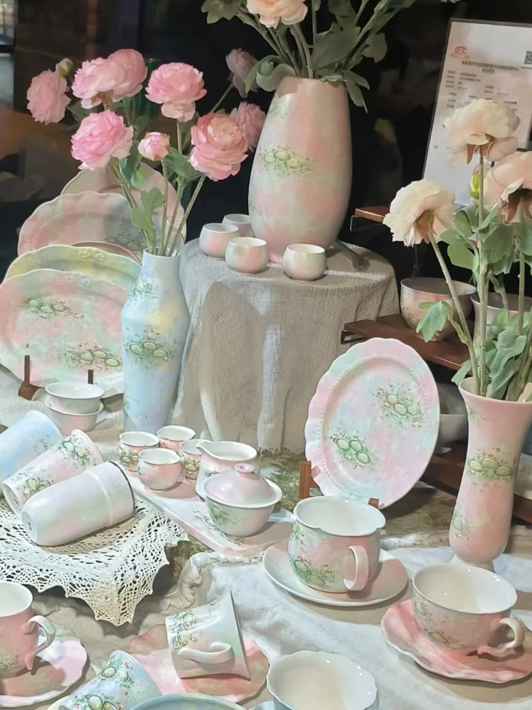 Pastel Jingdezhen ceramic vases, cups, and small porcelain objects arranged on a tabletop