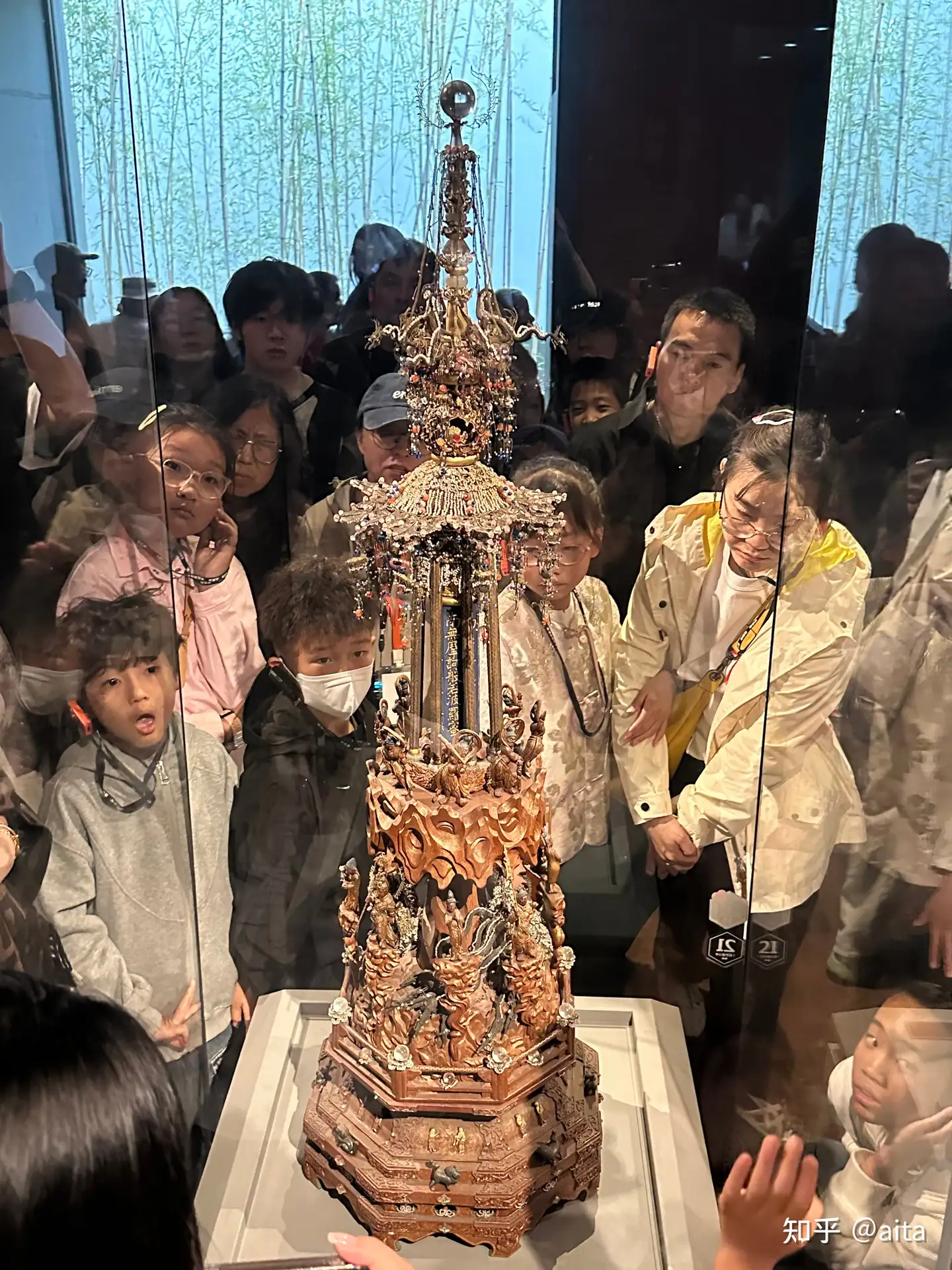 Visitors looking at an ornate relic inside Suzhou Museum